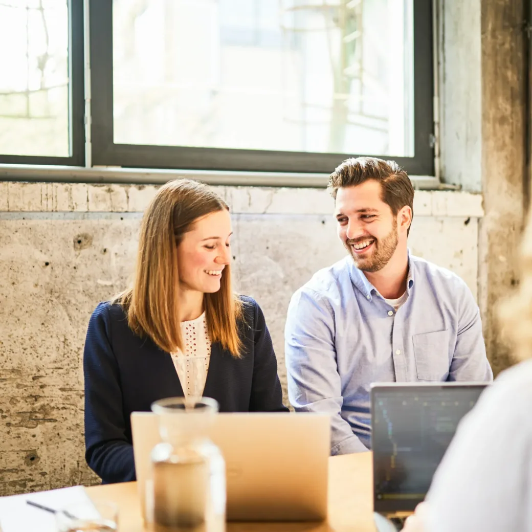 Photo of a woman and a man engaged in a friendly conversation.
