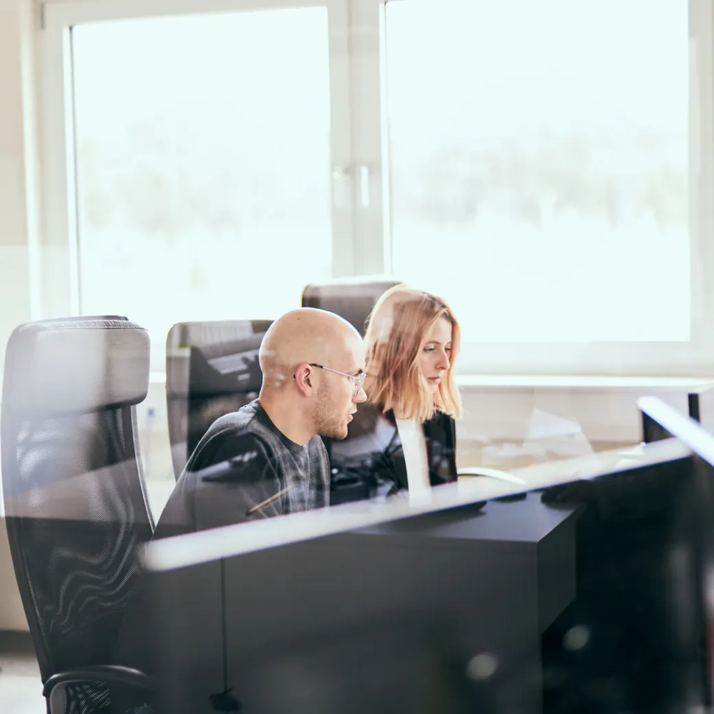 Image of two businessmen looking at a tablet in an office