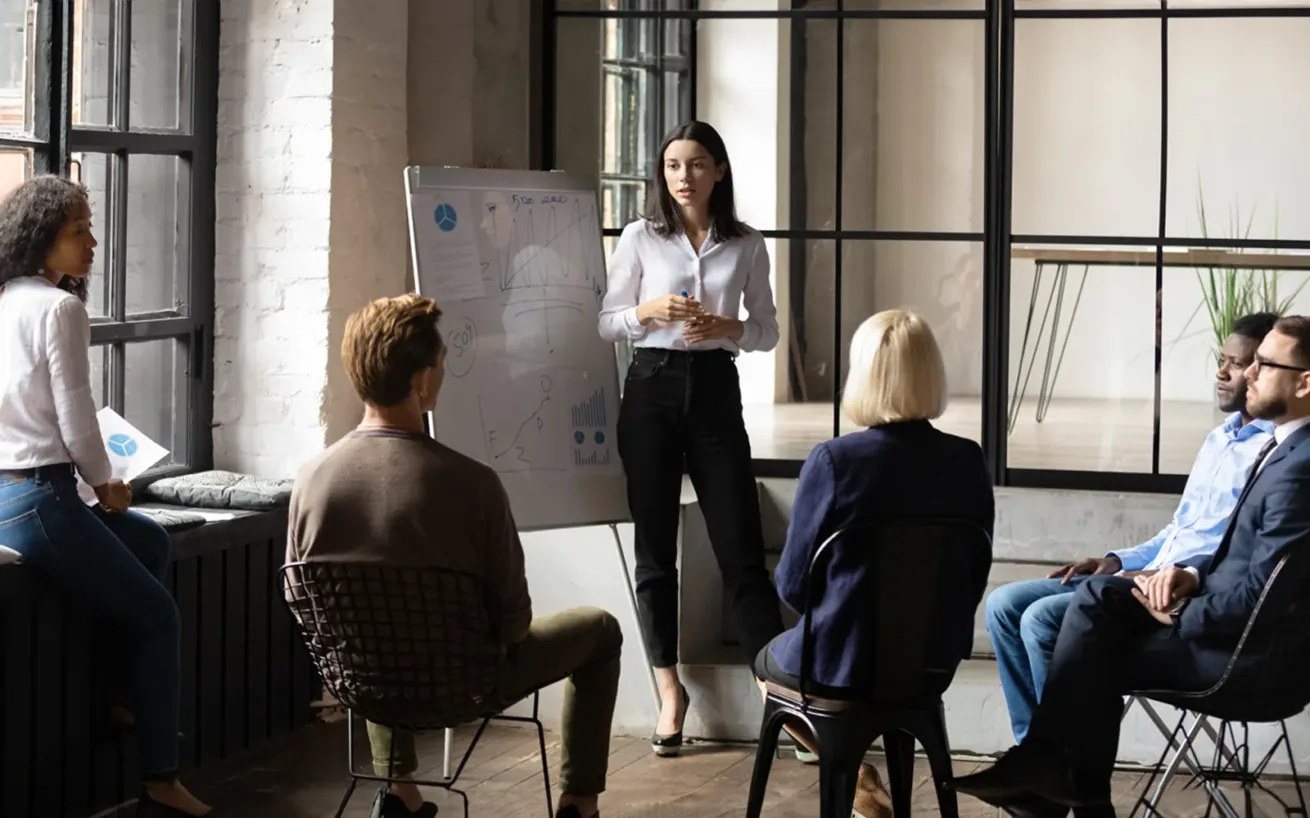 Confident lady business trainer coach leader give flip chart presentation