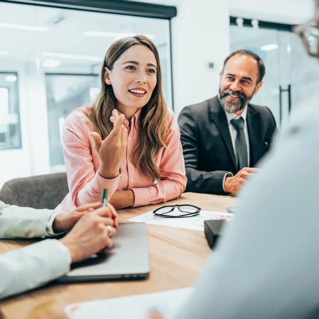 Modern business team discussing new ideas at the office. Business people on meeting in modern office. Colleagues smiling and talking at board room. Brainstorming