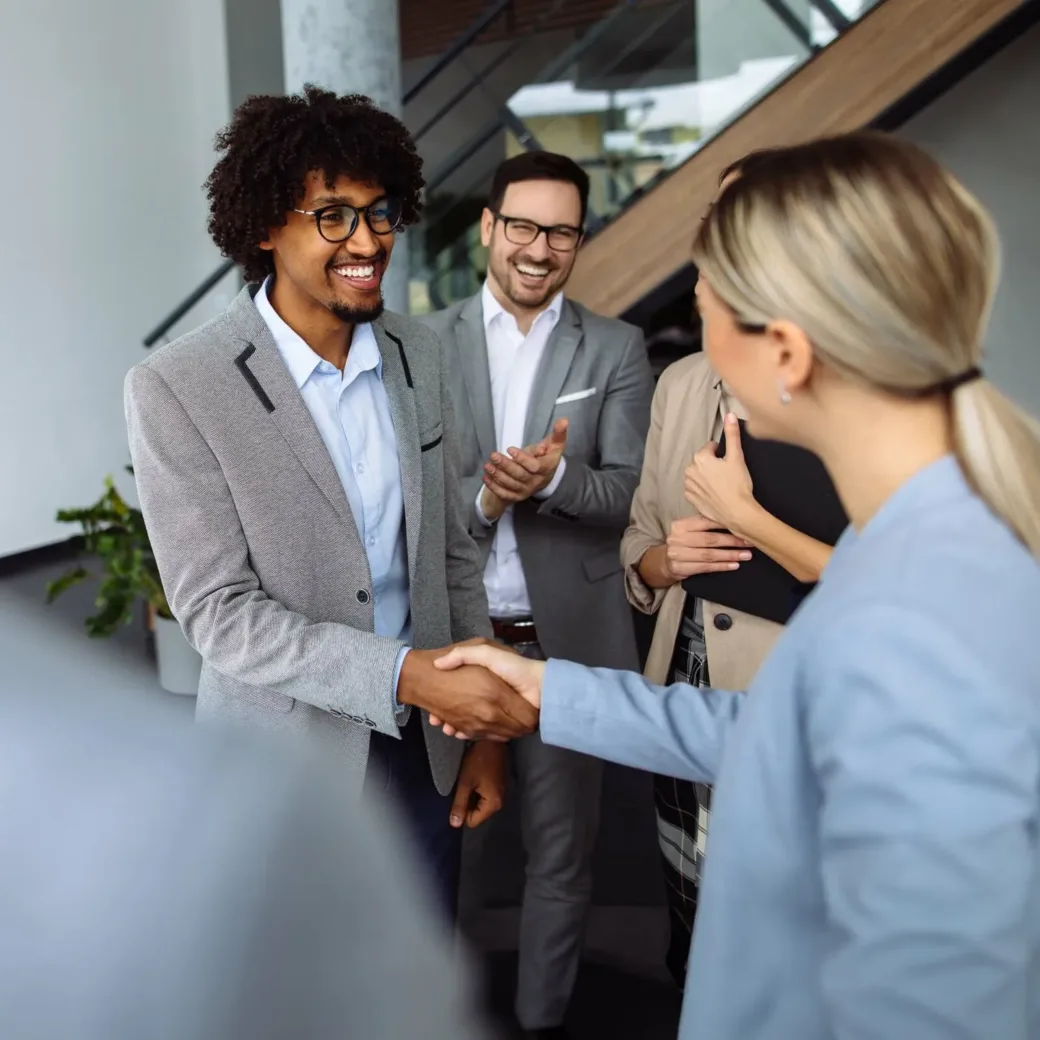 Business people shaking hands in the office hallway