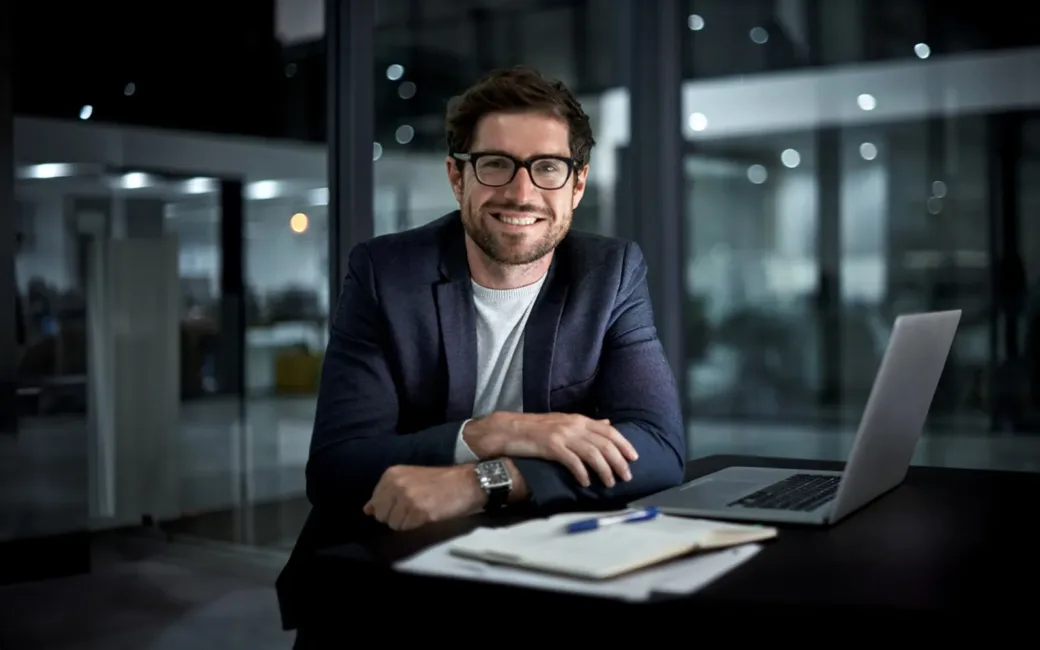 portrait of a happy young businessman working at his office desk