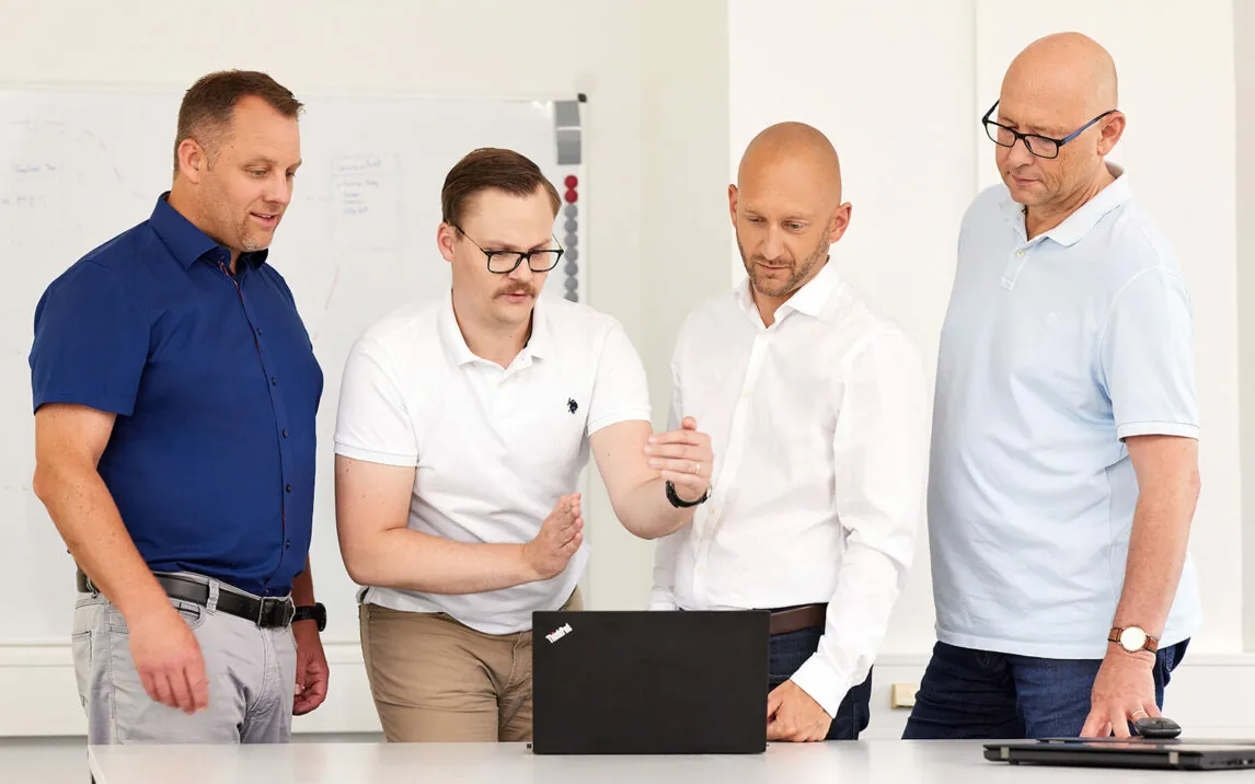 Image of PlastiVation employees looking at a laptop computer | PlastiVation Plans and Designs Product Lifecycle Management (PLM) With valantic’s Help