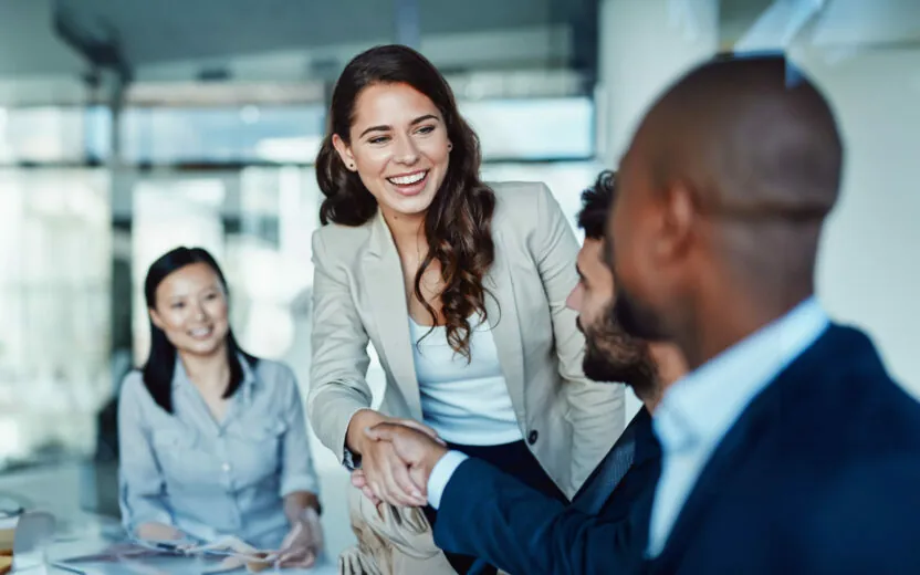 Shot of a young businesswoman shaking hands with a colleague during a meeting in a modern office