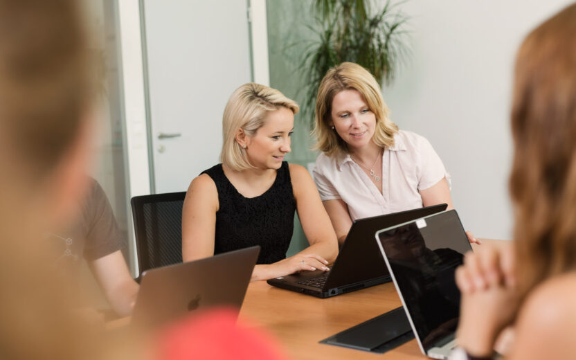 Image of two valantic employees looking into a laptop