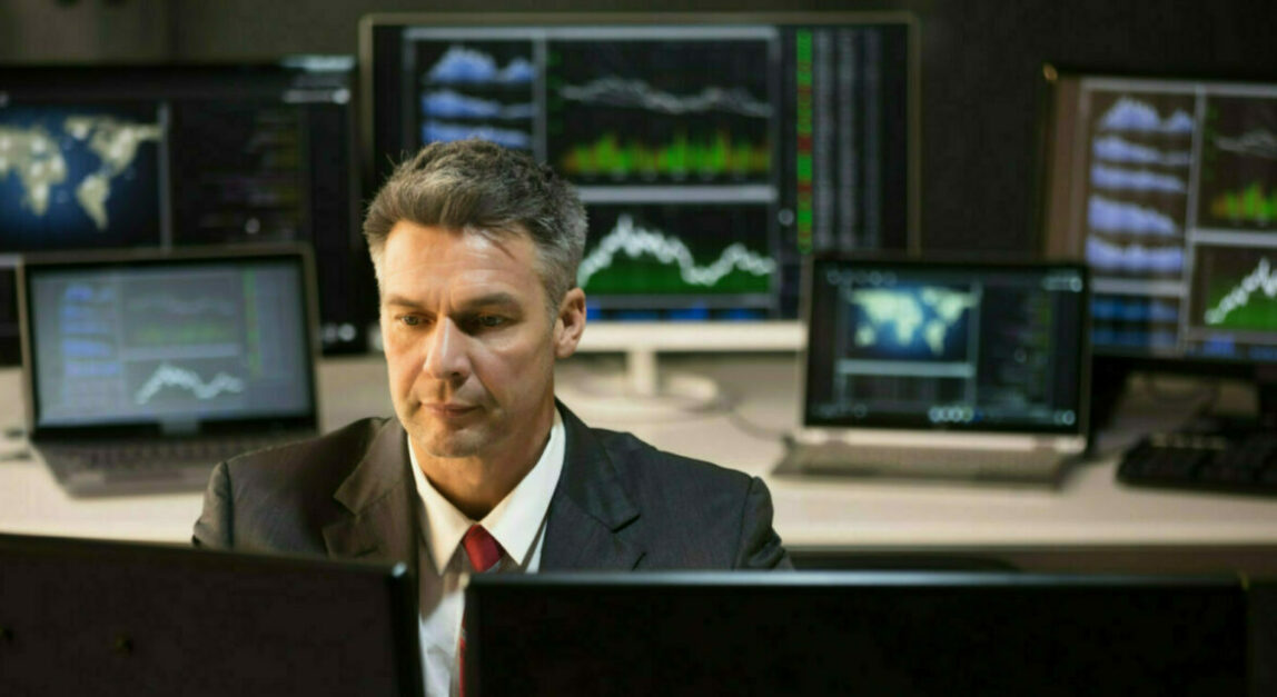 Image of financial market and business man in front of screen