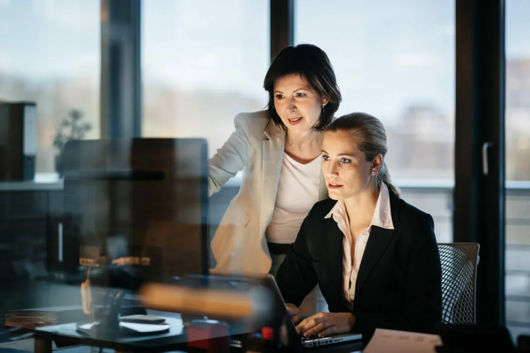 Picture of two business women looking at the screen