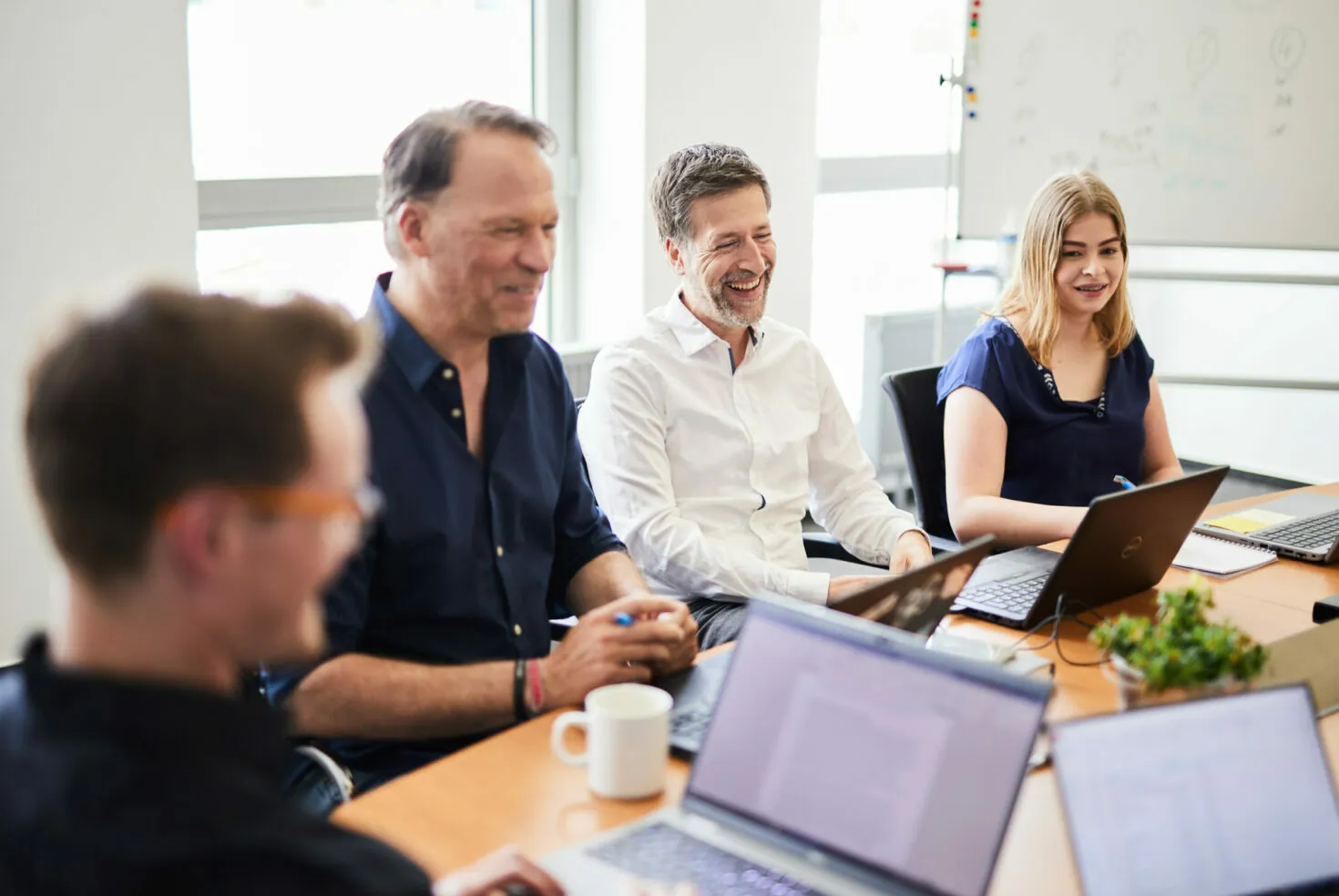 A group of colleagues having fun in a meeting.