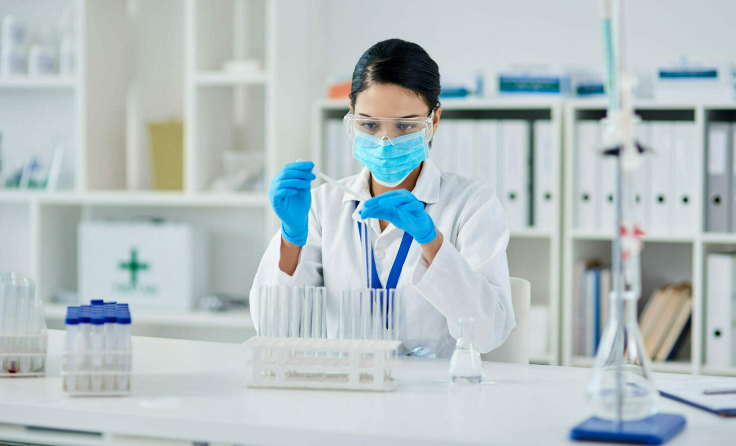 Laboratory employee in front of test tube