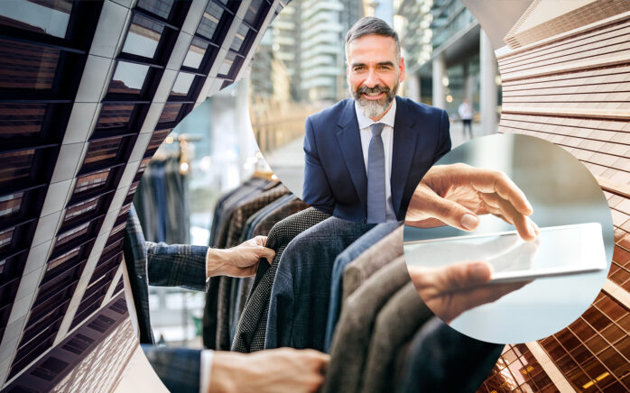 imagem com fundo de edificios, homem a escolher blazer, tablet e homem de negócios sorridente