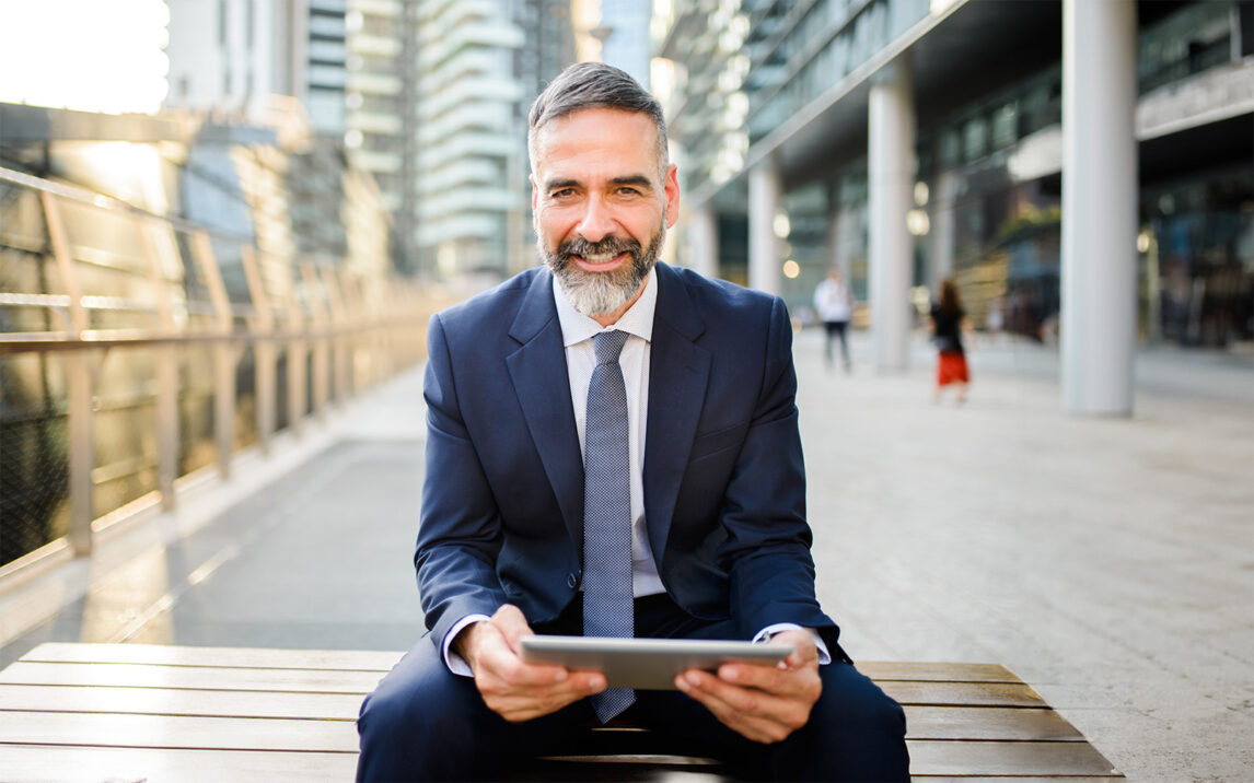 Mature businessman using digital tablet