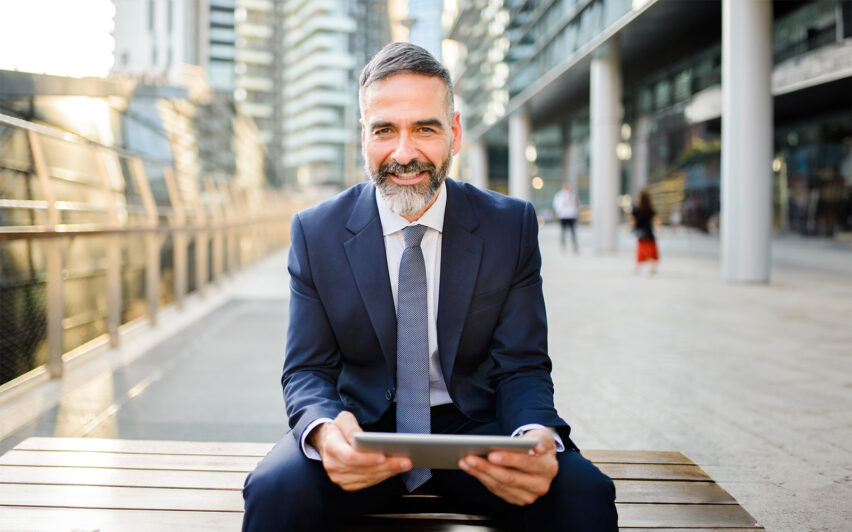 Mature businessman using digital tablet