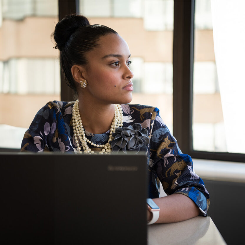 Businesswoman with laptop looking to the side