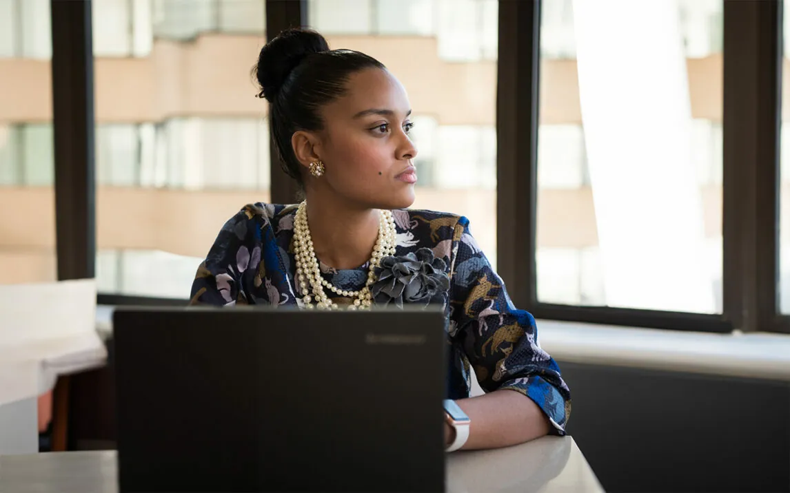 Businesswoman with laptop looking to the side