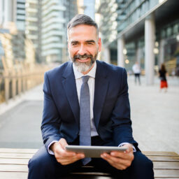 Mature businessman using digital tablet