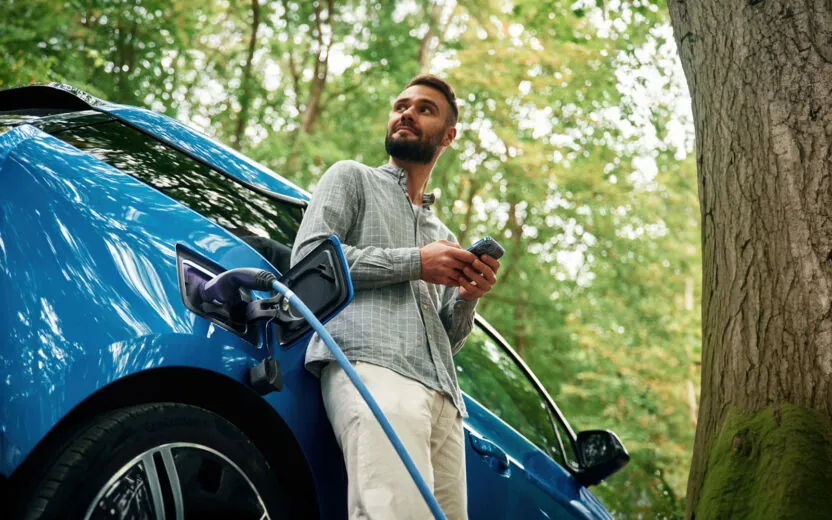 man charging electric car