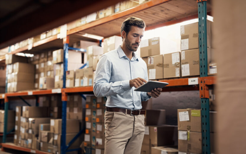 Shot of a young man using a digital tablet while working in a warehouse