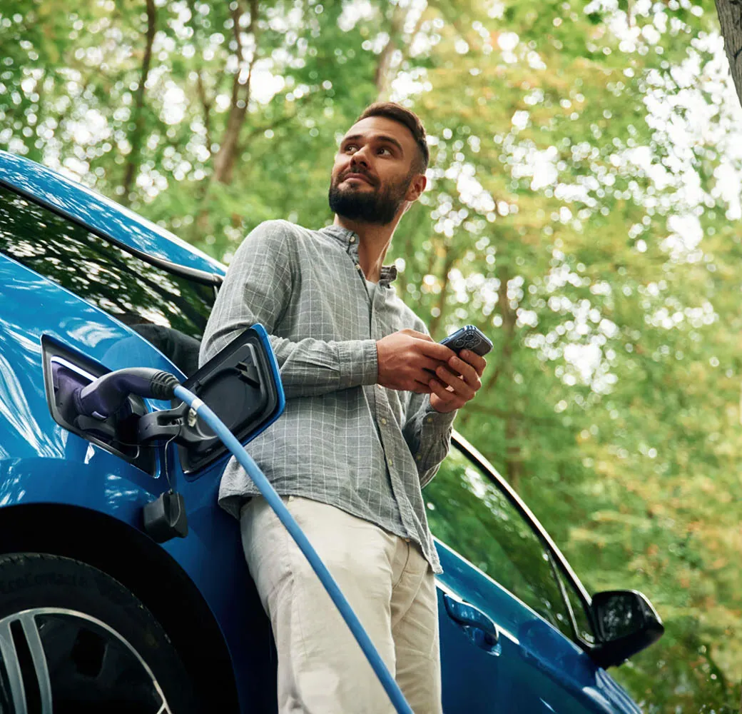 man charging electric car