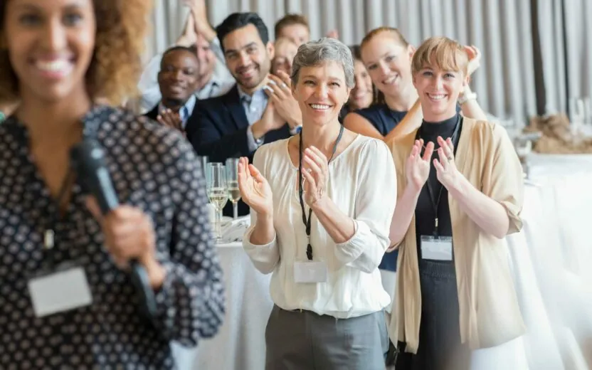 Group of people applauding after speech during conference