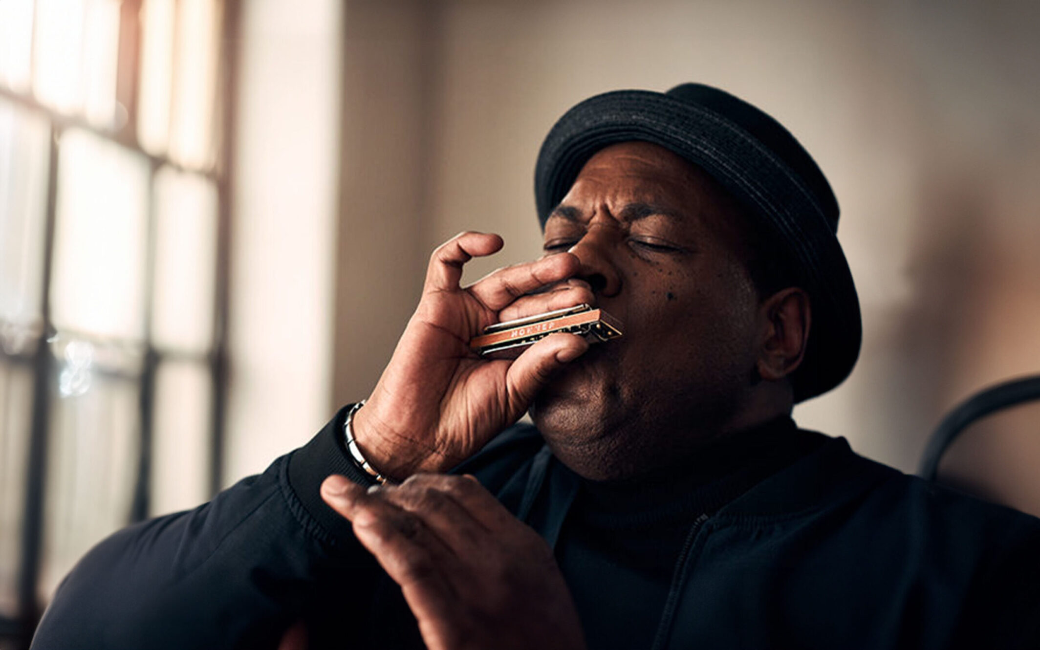Picture of musician and music producer Keith Dunn with a harmonica from HOHNER