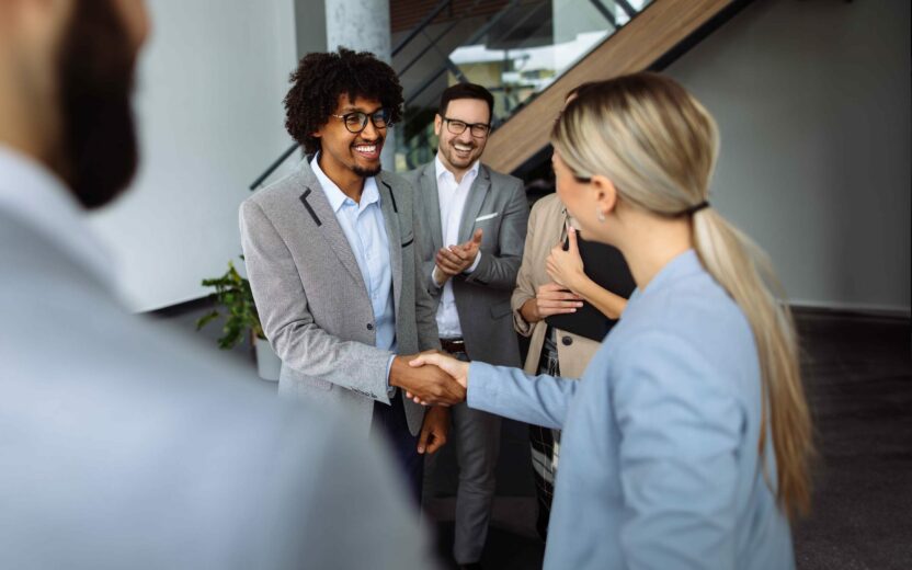 Business people shaking hands in the office hallway