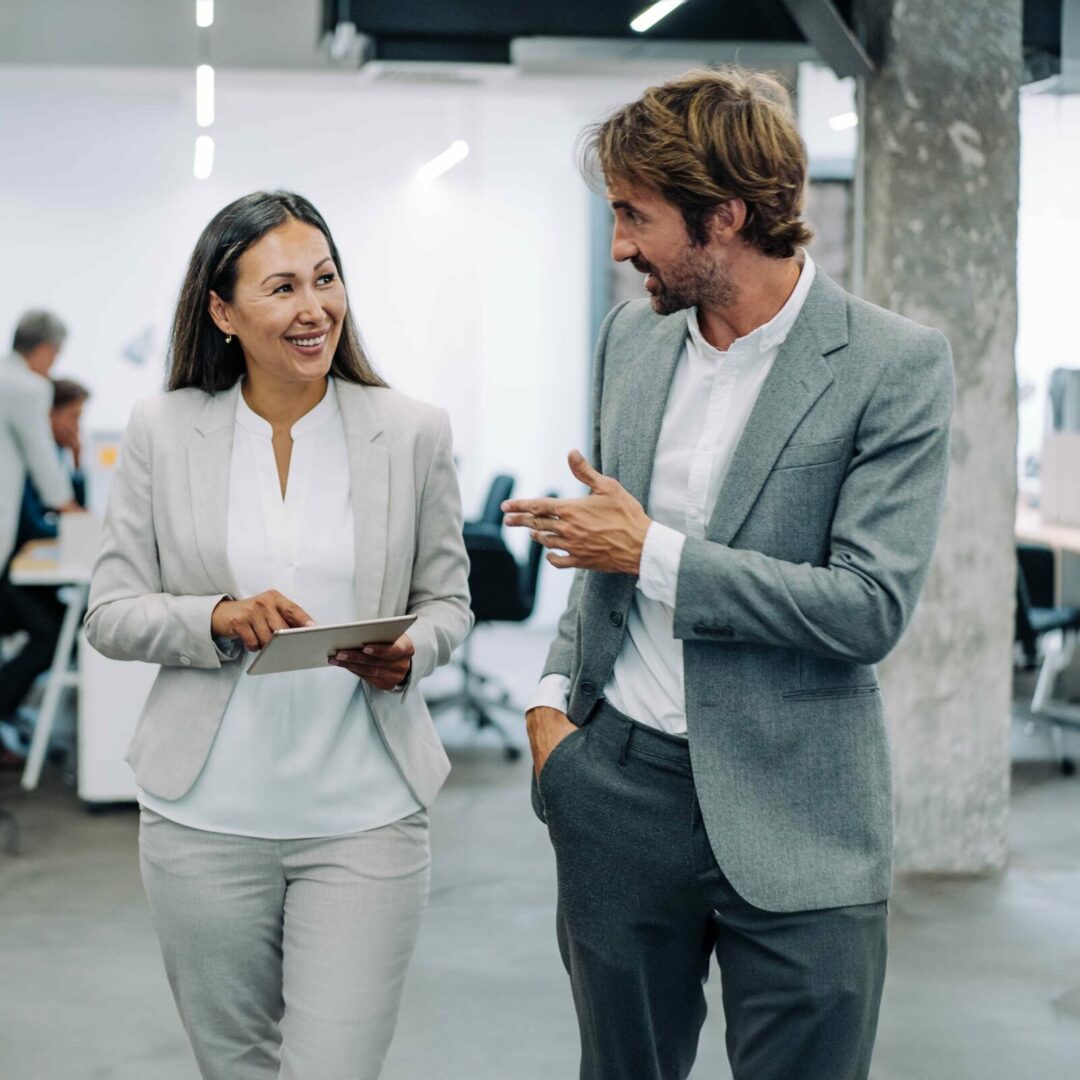 Business woman and man talking in office