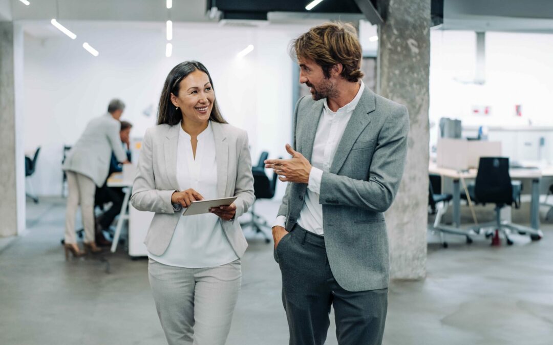 Business woman and man talking in office