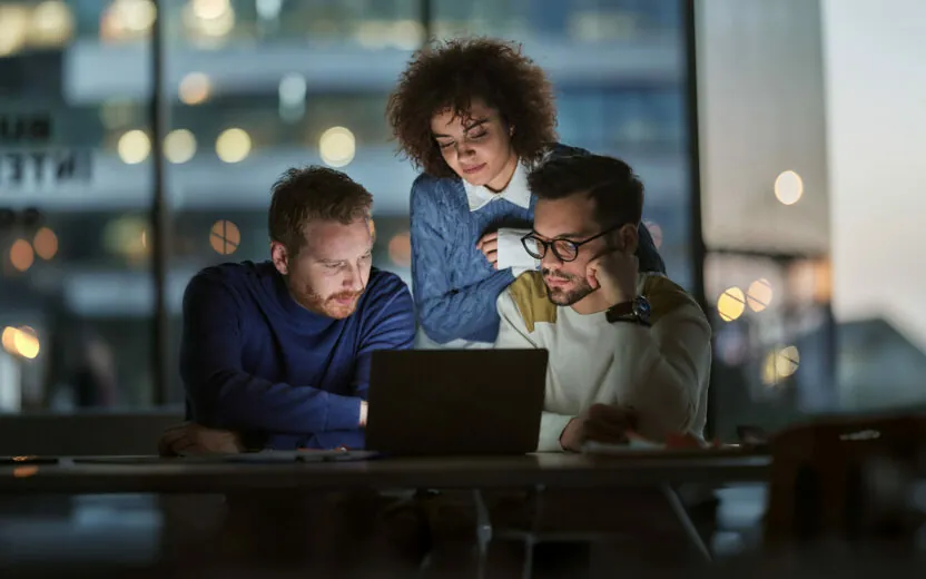 Business team working on a computer late in the office.