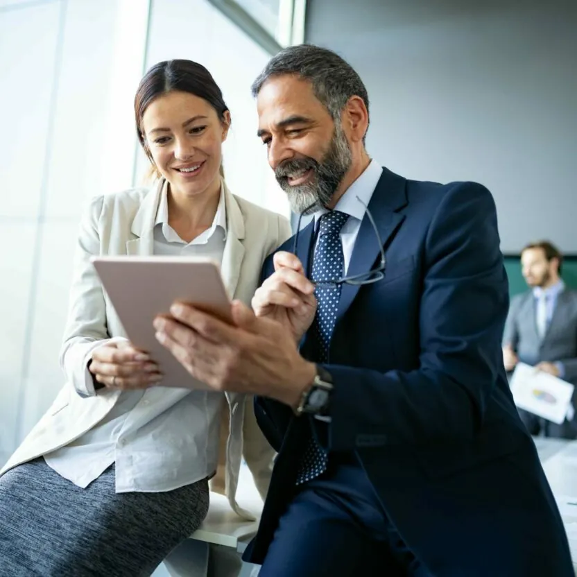 Business colleagues in modern office using tablet