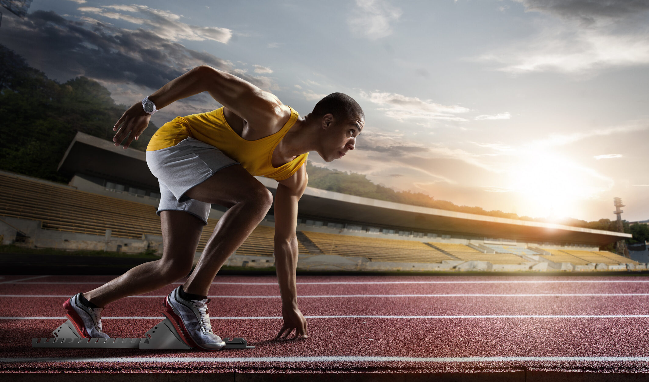 Sport. Sprinter leaving starting blocks on the running track. | KI-Consulting & Strategy
