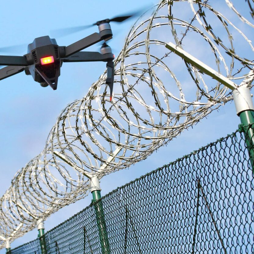 drone-monitoring-barbed-wire-fence-on-restricted-area-959932976
