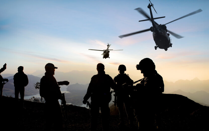 silhouettes of soldiers during military mission at dusk
