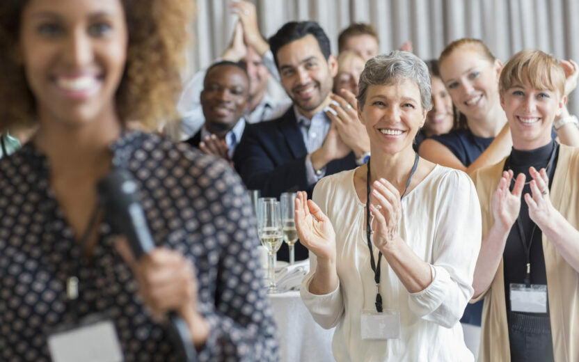 Group of people applauding after speech during conference