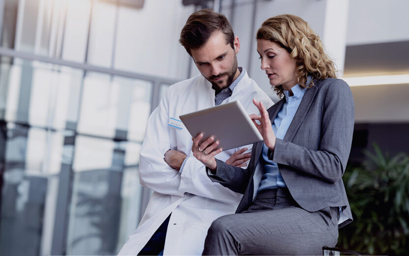 Businesswoman with tablet talking with doctor