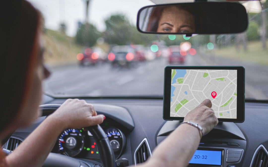 Woman Sitting In Car And Using Navigation System