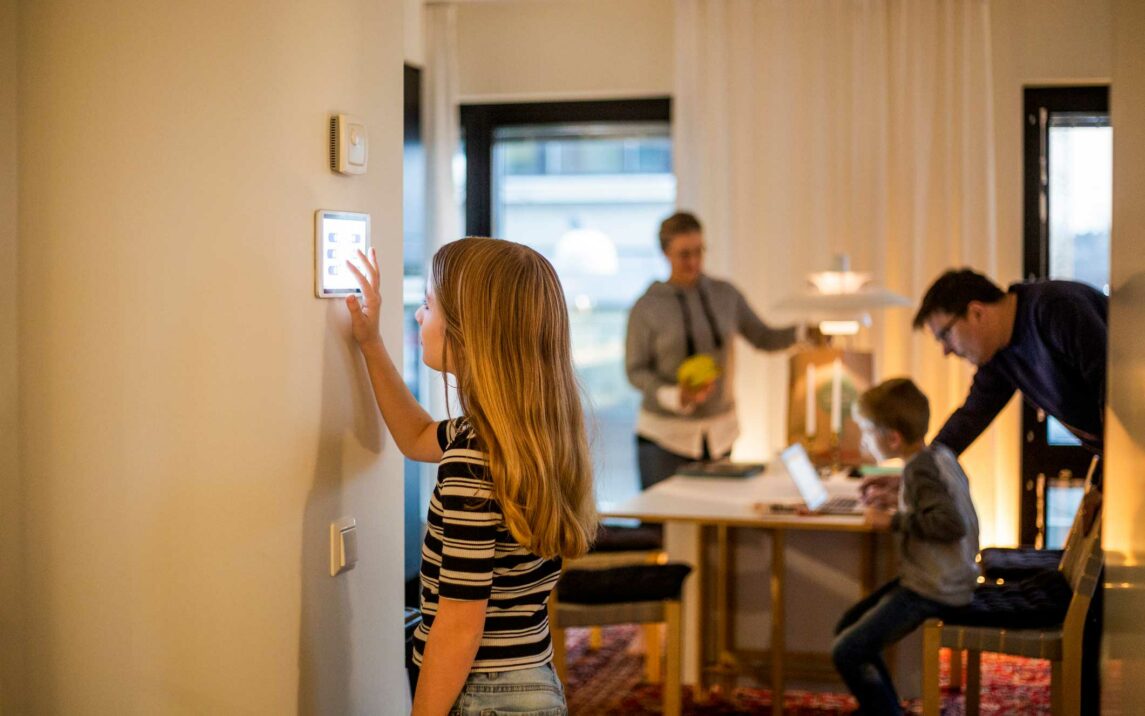 girl using digital tablet on wall with family