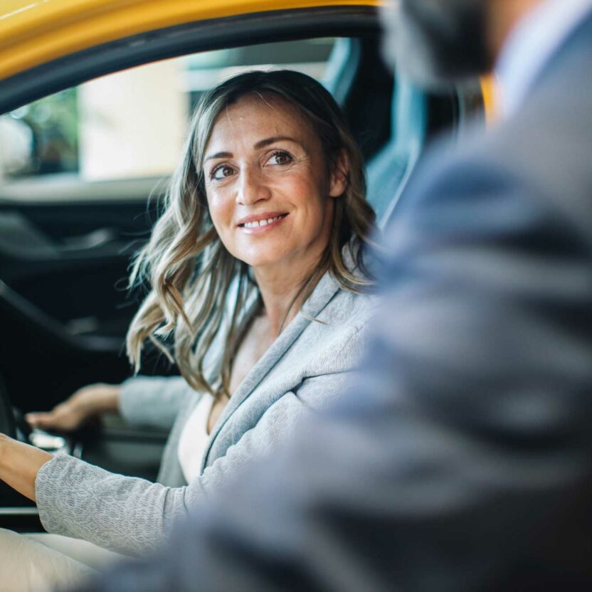 businesswoman looking for a new car