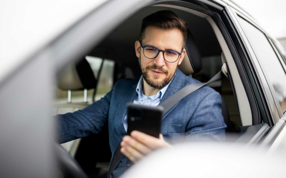businessman texting and driving in his car