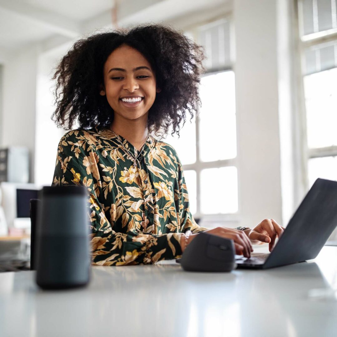 Woman using smart speaker while working in office