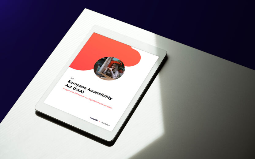 Tablet on a table displaying a document titled "European Accessibility Act (EAA)" with a circular photo and red design elements.