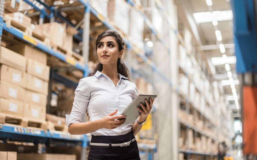woman standing in warehouse with IPad