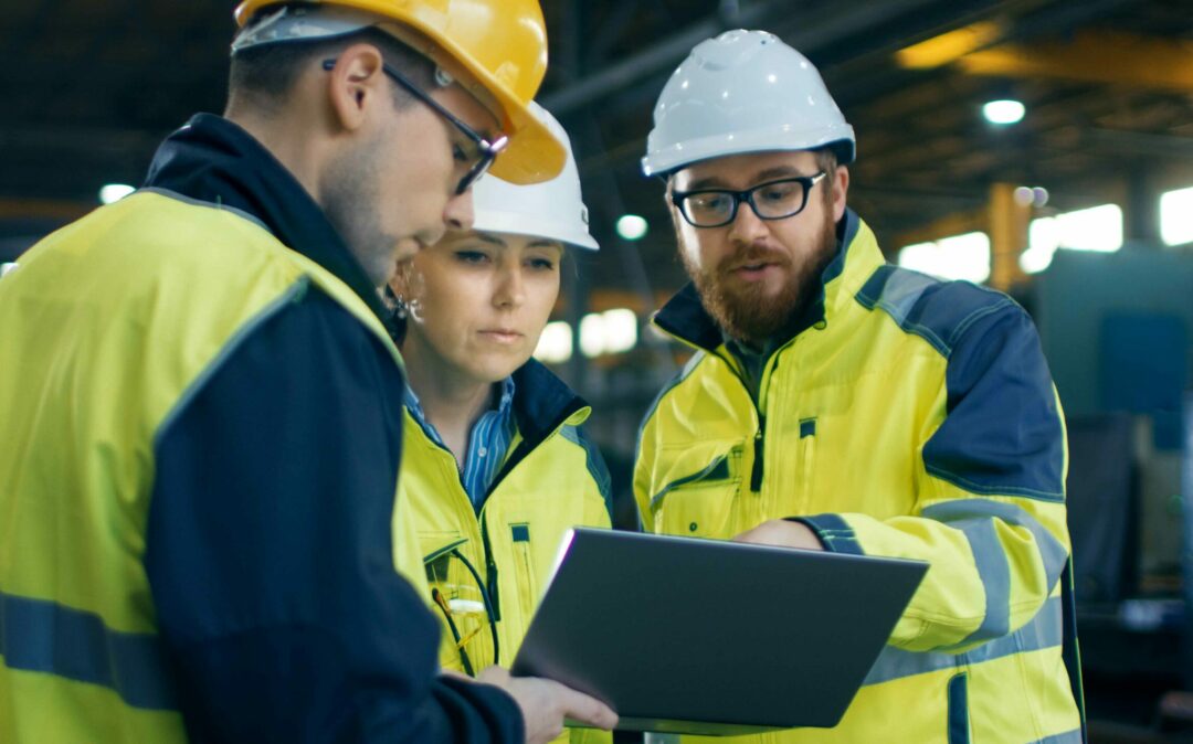 group of 3 people chatting and working in factory building with sap s/4hana