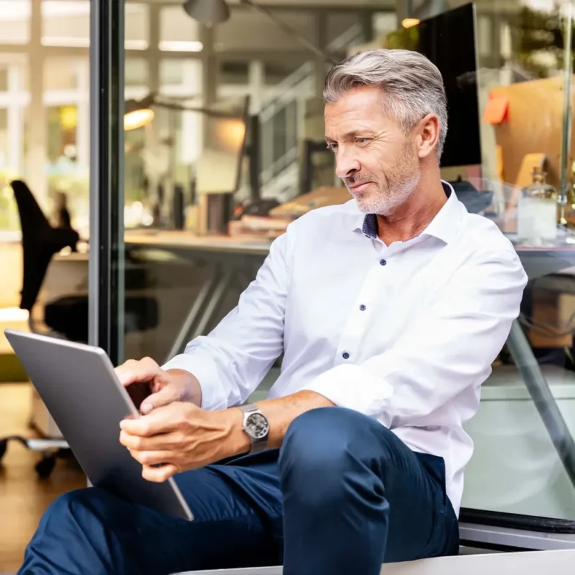 businessman working on digital tablet while sitting