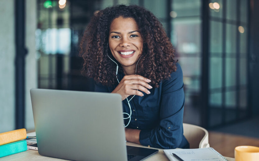 Businesswoman with laptop and headphones in the office