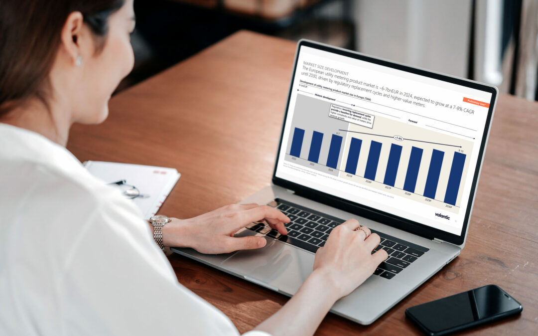 A woman sitting in front of a laptop screen which displays a slide on the smart metering solutions dach market trends.