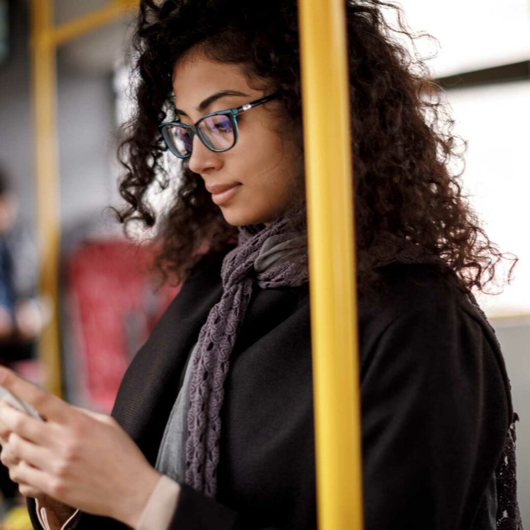 young-woman-traveling-by-bus-and-using-smart-phone