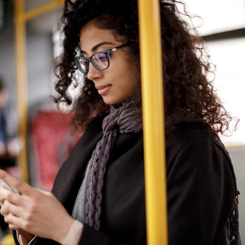 young-woman-traveling-by-bus-and-using-smart-phone