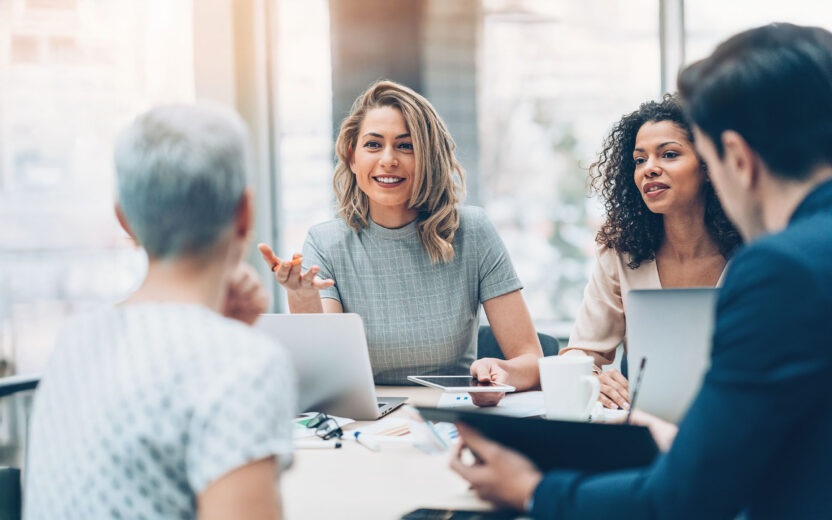 Group of employees having a meeting in a light environment.