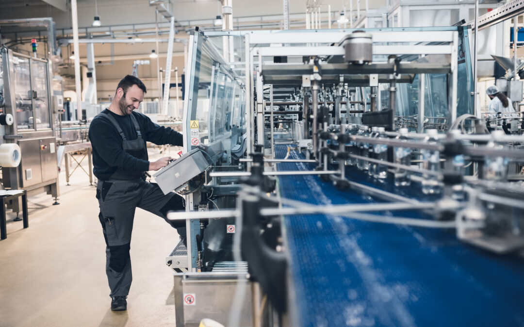 man standing in front of production machine