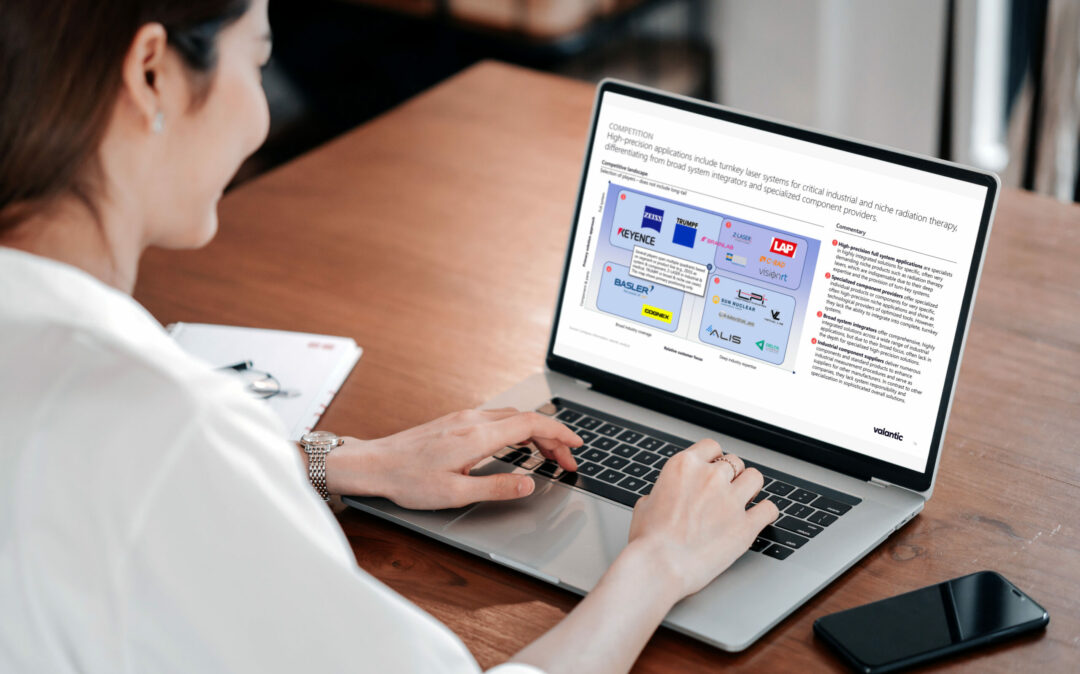 A woman sitting in front of a laptop screen which displays a slide on the medical laser applications dach market competitive landscape.